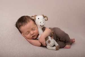 Newborn boy and giraffe