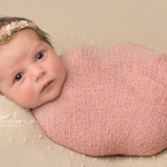 baby wrapped in pink wrap