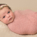 baby wrapped in pink wrap
